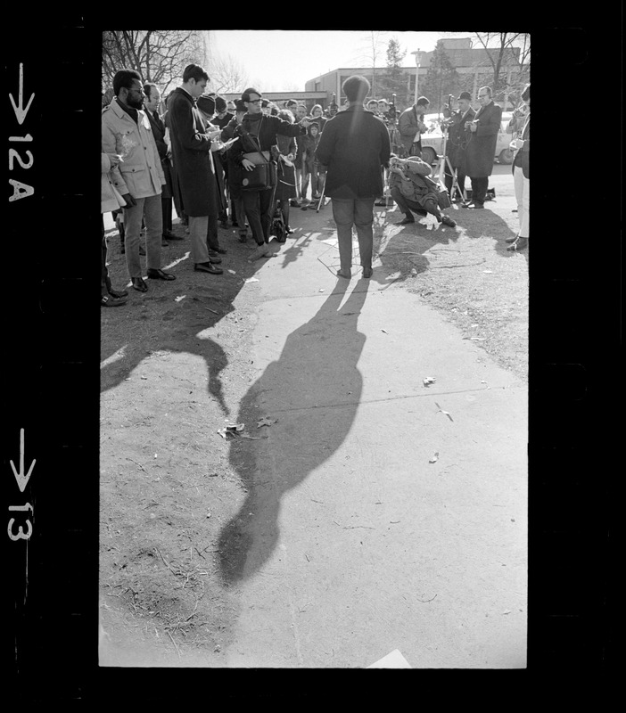 Randall Bailey seen from behind outside of Ford Hall talking to press during Brandeis University sit-in