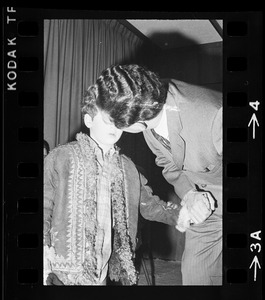 Brandeis University President Morris Abram leaning over and talking to his son Joshua