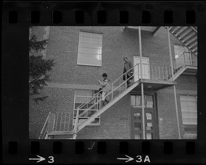 Students leave Ford Hall by the second-story rear fire escape