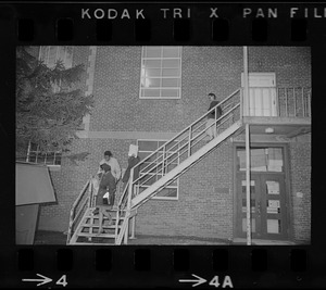 Students leave Ford Hall by the second-story rear fire escape