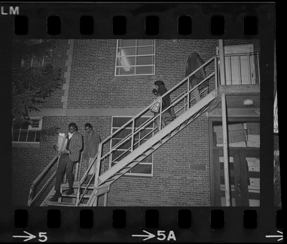 Students leave Ford Hall by the second-story rear fire escape