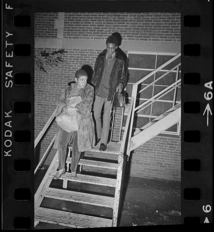 Students leave Ford Hall by the second-story rear fire escape