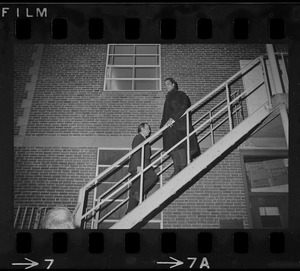 Men, possibly students, on back stairs of Ford Hall by the second-story rear fire escape