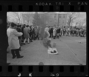 Brandeis students watch symbolic dolls go up in flames during demonstration on campus