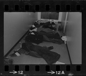 Seven students sleep in hall near doorway