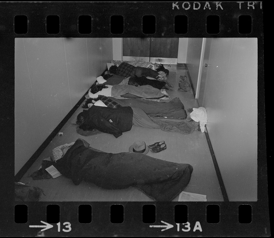 Seven students sleep in hall near doorway