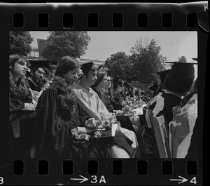 Row of students with flowers at Brandeis University commencement
