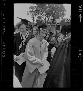 Students at Brandeis University commencement exercises with customized robe and cap