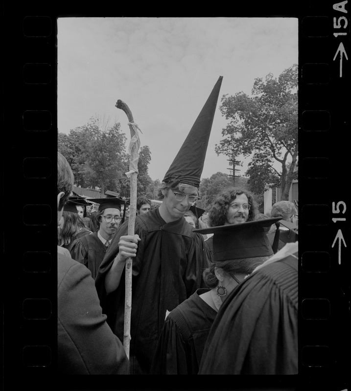 Student at Brandeis University commencement exercises wearing a dunce cap and carrying a stick