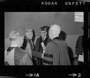 Former Supreme Court Chief Justice Earl Warren and Richard Cardinal Cushing talking with others at Boston College commencement