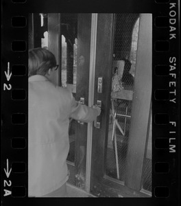 Person pulling on doors at Boston College sit-in