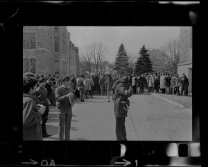Cameraman seen in front of a crowd at Boston College sit-in