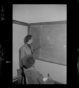 Students drafting demands on chalkboard during Boston College sit-in by 30 black students