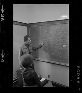 Students drafting demands on chalkboard during Boston College sit-in by 30 black students