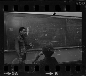 Two students in front of blackboard at Boston College sit-in by 30 black students