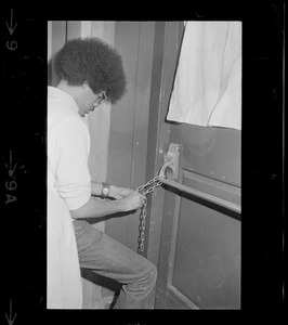 Student chaining door at Boston College during sit-in