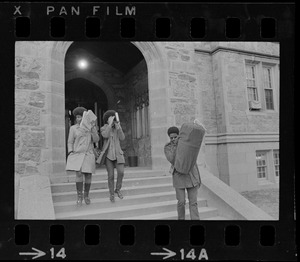 Students leaving Gasson Hall at Boston College during sit-in and covering their faces