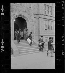 Students leaving Gasson Hall at Boston College during sit-in and carrying items