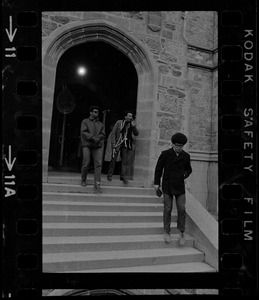 Students leaving Gasson Hall at Boston College during sit-in with one student is carrying chains