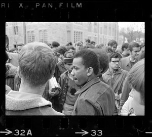 Representative of the black group surrounded by a crowd during Boston College sit-in