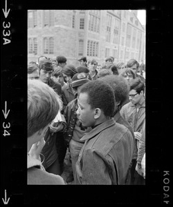 Representative of the black group surrounded by a crowd during Boston College sit-in