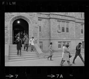 Students leaving Gasson Hall while hiding their faces during Boston College sit-in