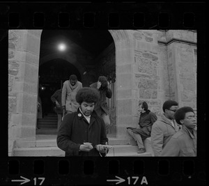 Students leaving Gasson Hall at Boston College during sit-in with some hiding their faces