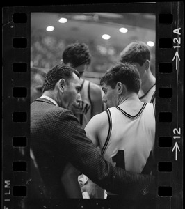 Boston College basketball coach Bob Cousy speaking to a player