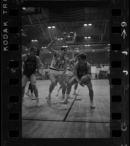 Boston College player (no. 52) in a play against Providence College player (no. 23) during a basketball game