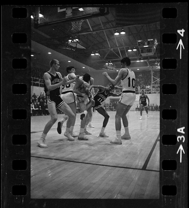 Boston College and Providence college basketball players trying to take possession of the ball during a game