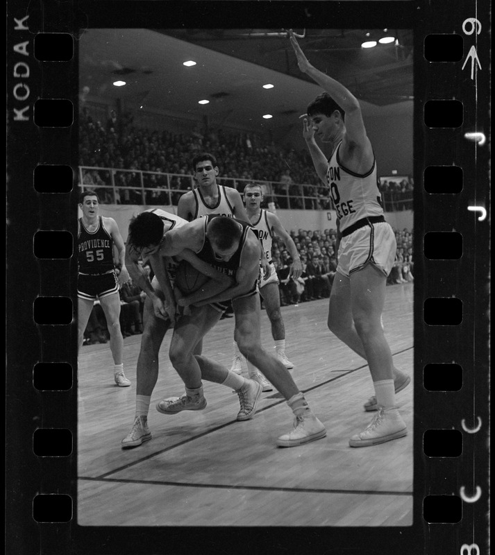 Providence College and Boston College basketball players each try to take possession of basketball during a game