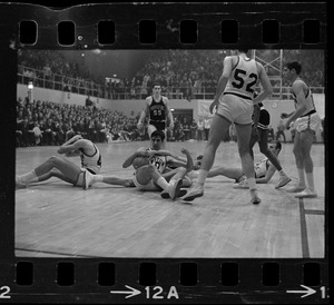 Boston College basketball players on the ground and maintaining possession of the ball during a game against Providence College