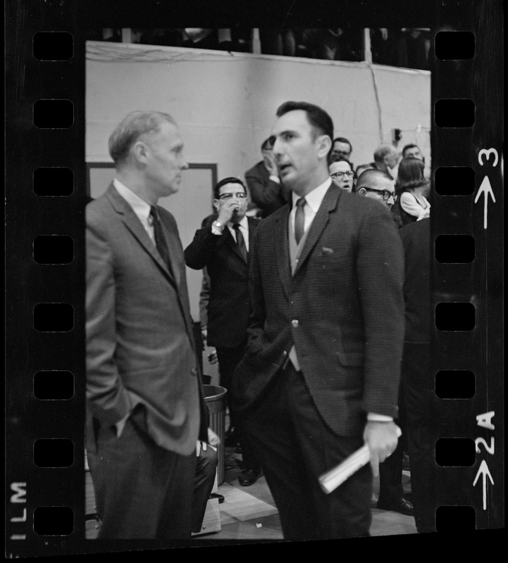 Boston College coach Bob Cousy talking to Providence College coach Joe Mullaney on the sidelines