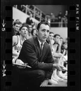 Boston College basketball coach Bob Cousy sitting on the bench during a game against Providence College