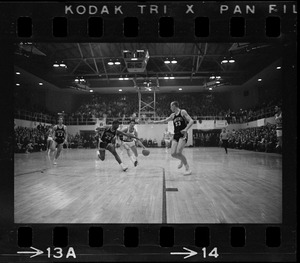 Boston College and Providence College players in basketball game, crowd in background
