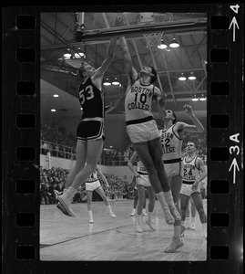 Boston College player (no. 10) and Providence College player (no. 53) jumping to the net during basketball game