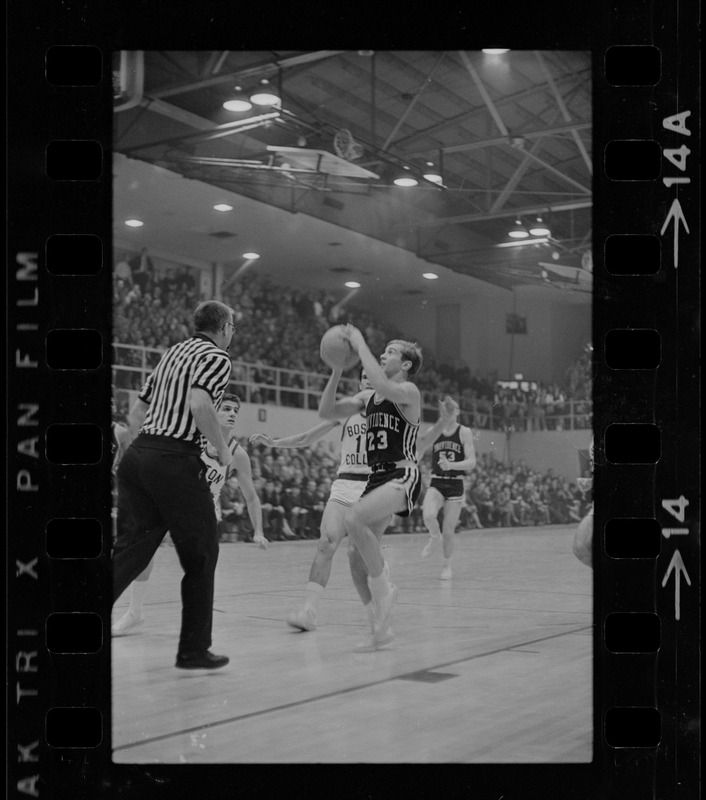 Providence College basketball player (no. 23) shooting the ball during a game against Boston College