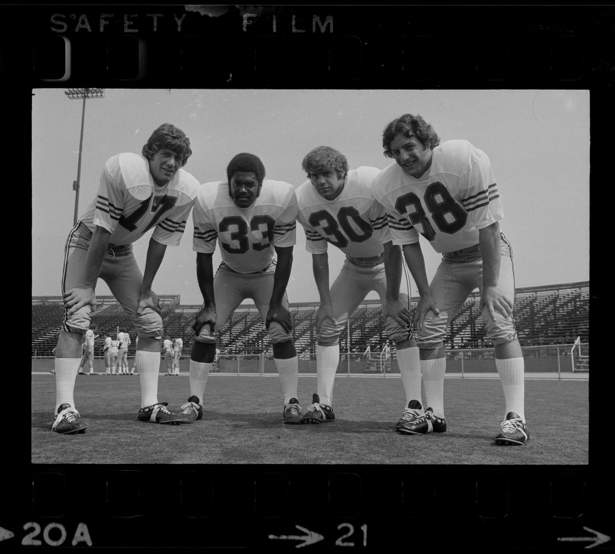 Boston College quarterback Joe Pandolfo (17), far left, and co-captain Dave Bucci (38), far right, pose with two other Boston College football players (no. 33 and no. 30)