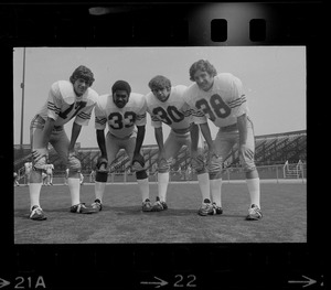 Boston College quarterback Joe Pandolfo (17), far left, and co-captain Dave Bucci (38), far right, pose with two other Boston College football players (no. 33 and no. 30)