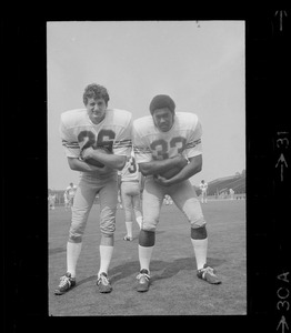 Boston College football players no. 28 and no. 33 cradle ball