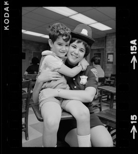 Female police officer hugging little boy