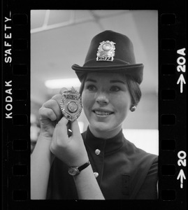 Newton's prettiest uniformed officer is Patricia MacMaster, 24, who shows her badge of authority and Irish derby cap
