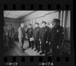 Police Comr. Edmund McNamara shakes hands with newly promoted lieutenants Earl B. Crocker, John J. Foley, Joseph V. Mills and Leroy B. Chase Jr.at the Boston Police Headquarters