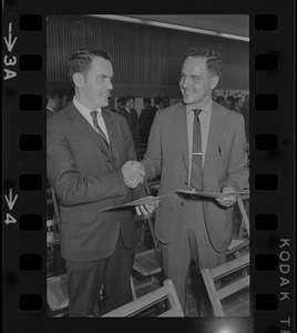 Two men in suits shaking hands