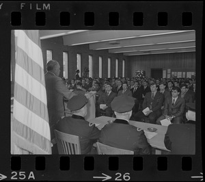 Police commissioner Edmund McNamara at podium speaking during ceremony for new police department recruits