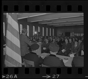 Police commissioner Edmund McNamara at podium speaking during ceremony for new police department recruits