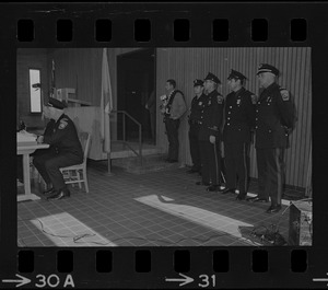 Officers standing during ceremony for new police department recruits