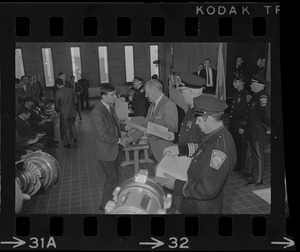 Police Comr. Edmund McNamara shakes hands with newly promoted lieutenants  Earl B. Crocker, John J. Foley, Joseph V. Mills and Leroy B. Chase Jr.at  the Boston Police Headquarters - Digital Commonwealth