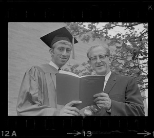 A Boston University graduate and National Education Assn. executive Leland Bradford pose with a commencement program