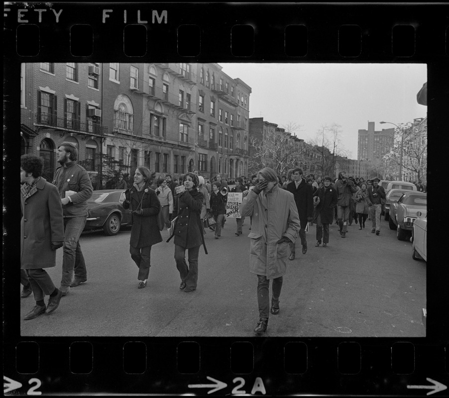 Boston University students walking down a street in protest